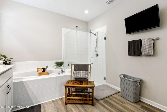 bathroom featuring vanity, shower with separate bathtub, and wood-type flooring