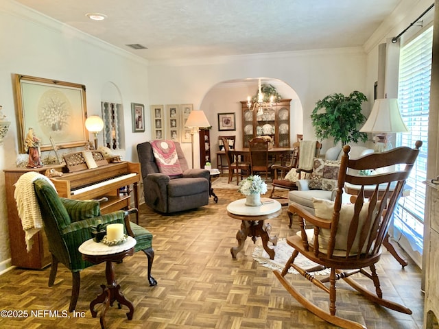 living area with crown molding, a textured ceiling, and light parquet flooring