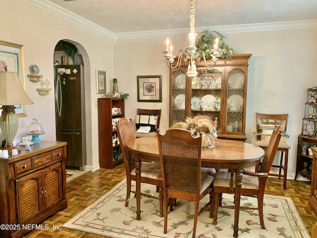 dining room with an inviting chandelier, crown molding, dark parquet floors, and a textured ceiling