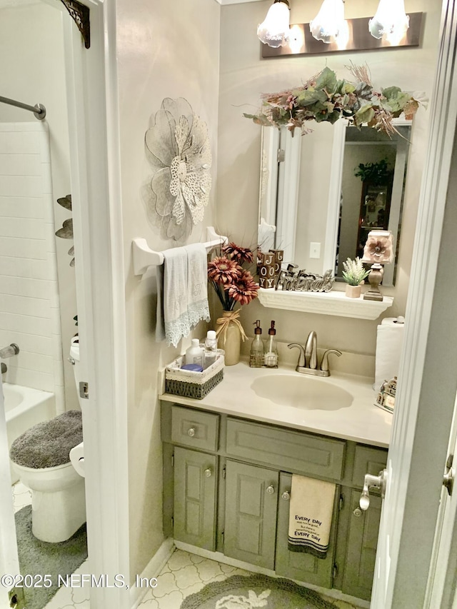 full bathroom featuring  shower combination, vanity, and toilet