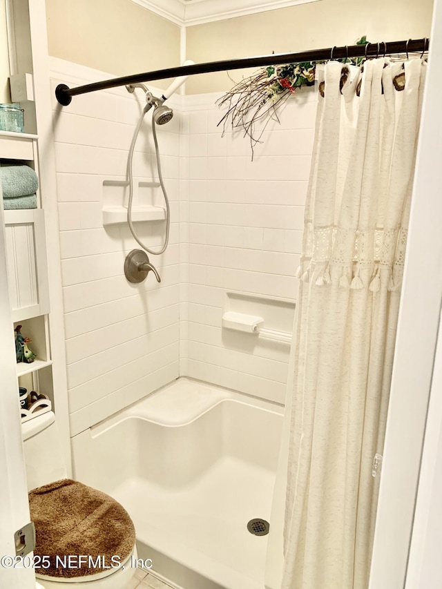 bathroom with ornamental molding and a shower with shower curtain