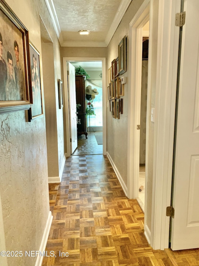 hall featuring crown molding, a textured ceiling, and light parquet flooring