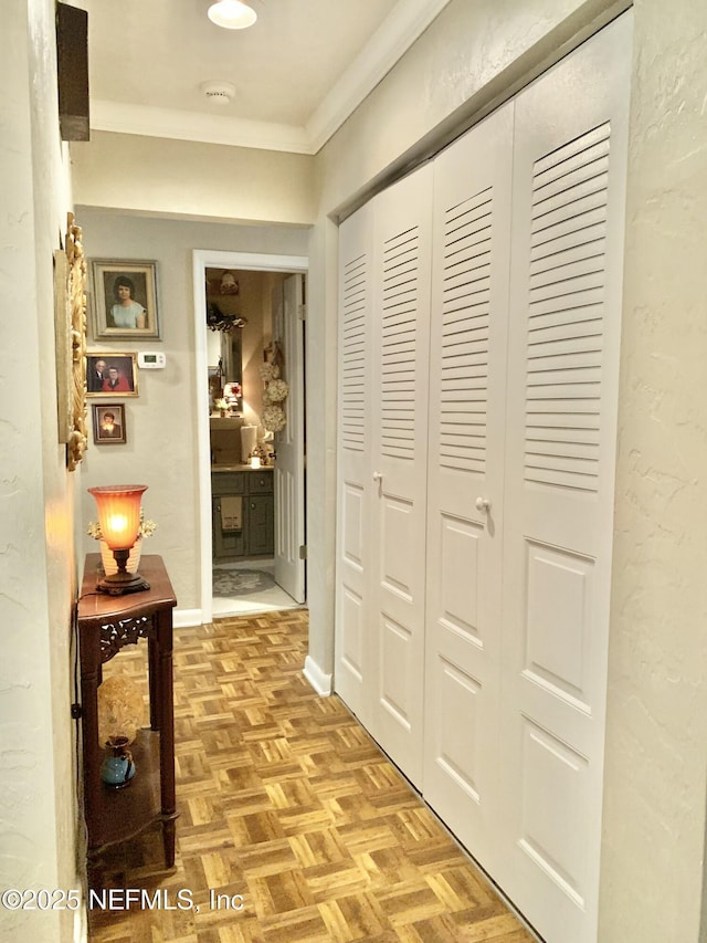 hall with crown molding and light parquet floors