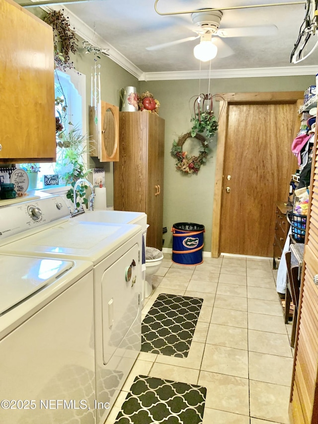 clothes washing area with ceiling fan, ornamental molding, washing machine and dryer, and light tile patterned floors