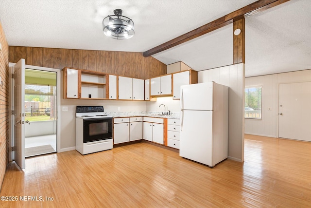 kitchen with vaulted ceiling with beams, electric range oven, white fridge, light hardwood / wood-style floors, and white cabinets