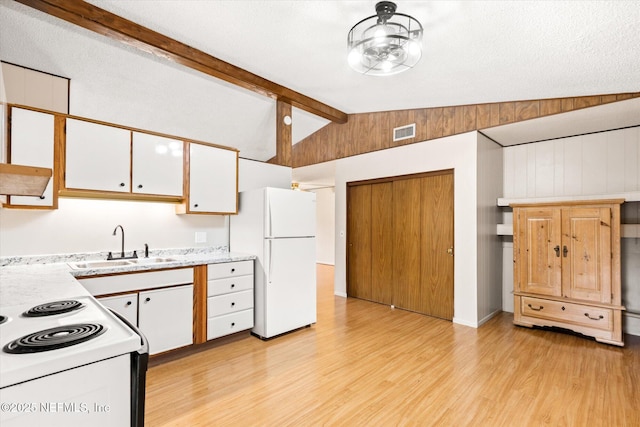 kitchen with lofted ceiling with beams, white cabinetry, sink, and white appliances