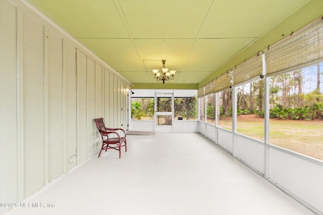 unfurnished sunroom with a notable chandelier