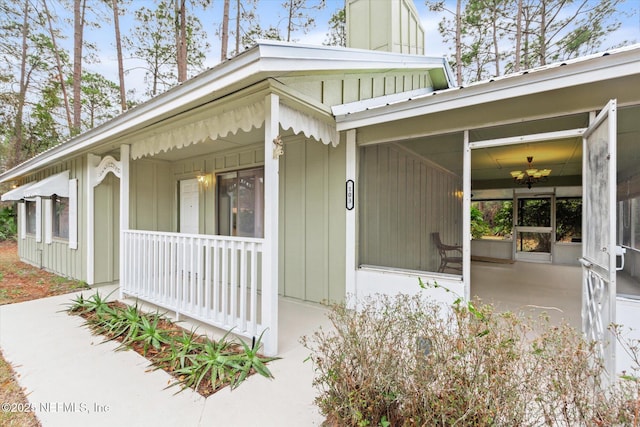 view of exterior entry with covered porch