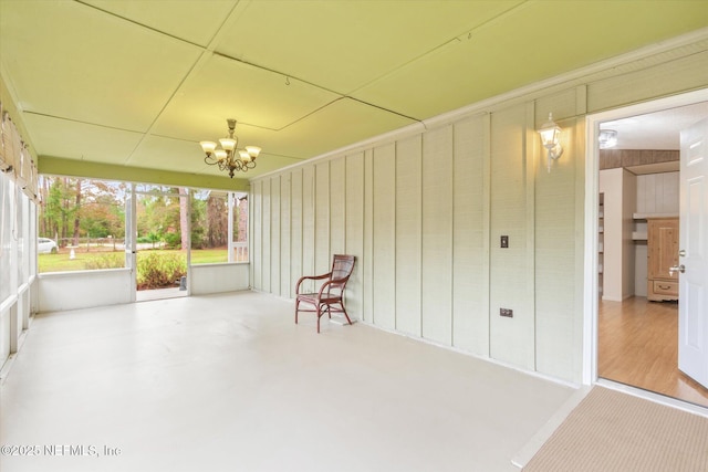 unfurnished sunroom with a chandelier