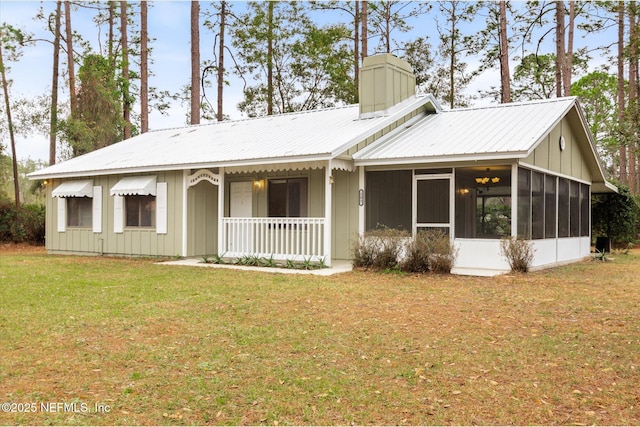 ranch-style home featuring a front lawn and a sunroom