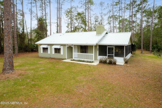 view of front of property featuring covered porch, a front lawn, and a sunroom