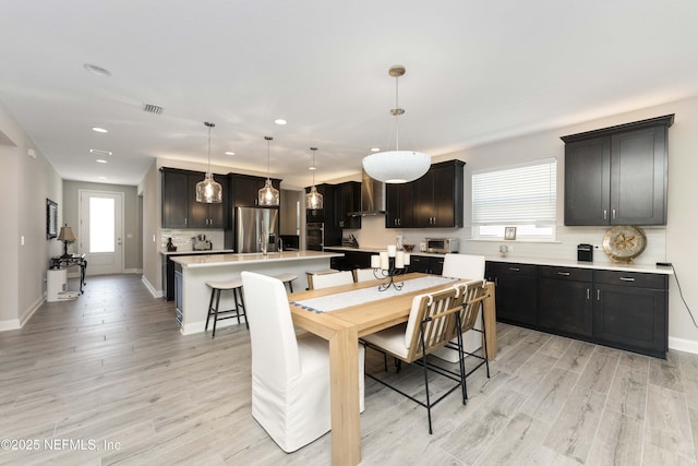 dining space with light hardwood / wood-style flooring