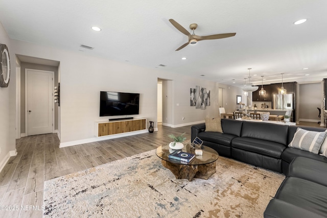 living room with hardwood / wood-style floors and ceiling fan