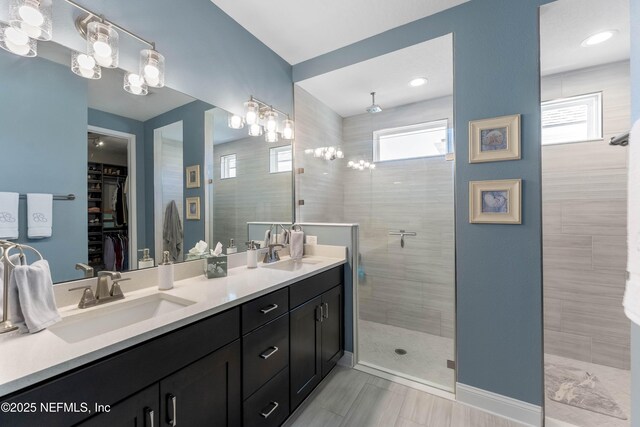 bathroom featuring vanity and a tile shower