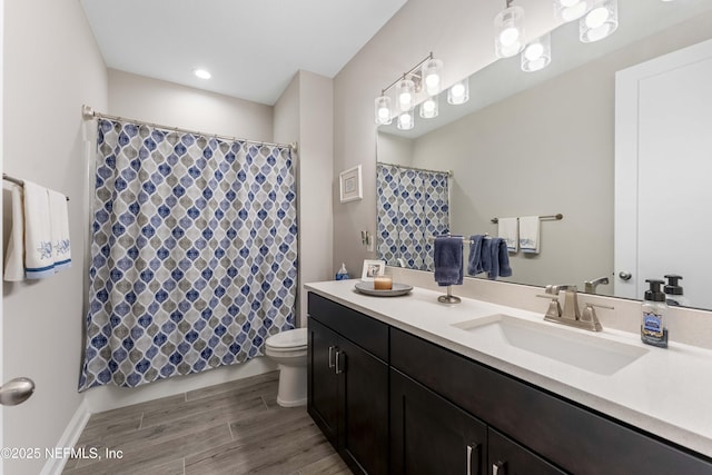 bathroom with vanity, toilet, and hardwood / wood-style floors