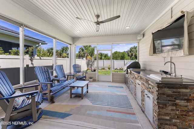 sunroom / solarium with sink, wooden ceiling, and ceiling fan