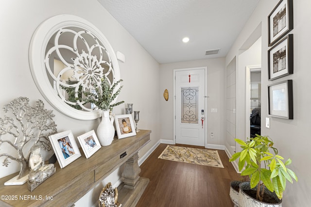 entrance foyer with wood-type flooring and a textured ceiling