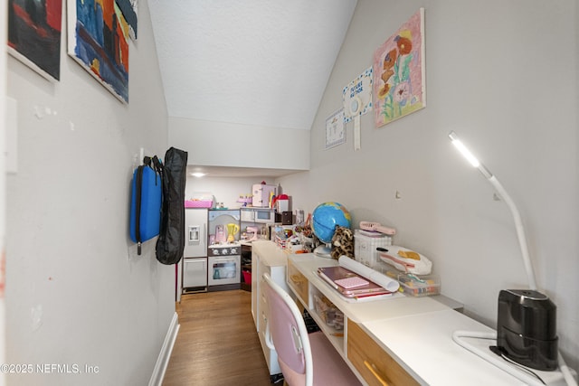 interior space with lofted ceiling, hardwood / wood-style floors, and a textured ceiling