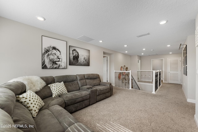 living room featuring light colored carpet and a textured ceiling