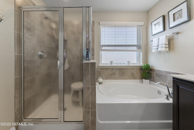 bathroom featuring vanity and shower with separate bathtub