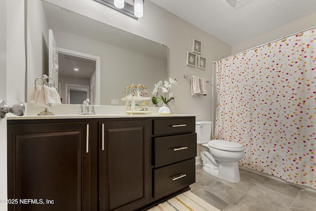 bathroom with vanity, walk in shower, a textured ceiling, and toilet