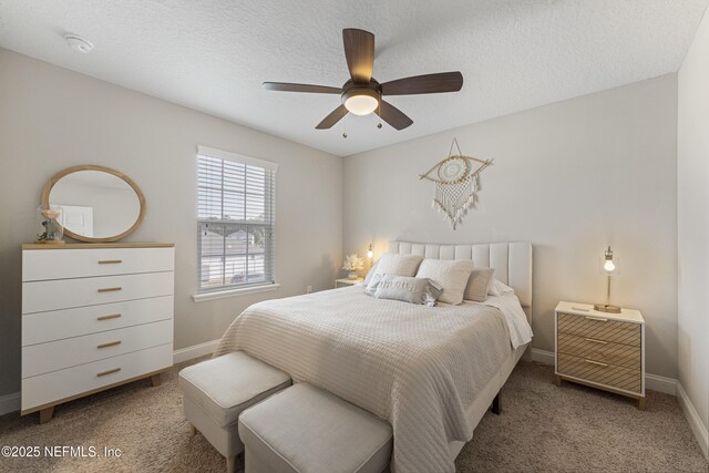 carpeted bedroom with ceiling fan and a textured ceiling