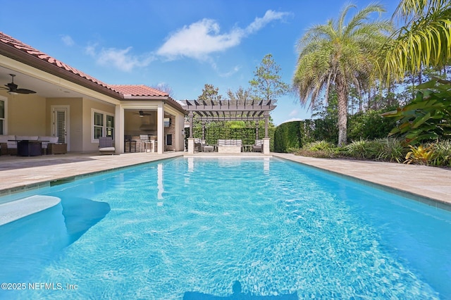 view of pool featuring ceiling fan, exterior bar, a patio area, and a pergola