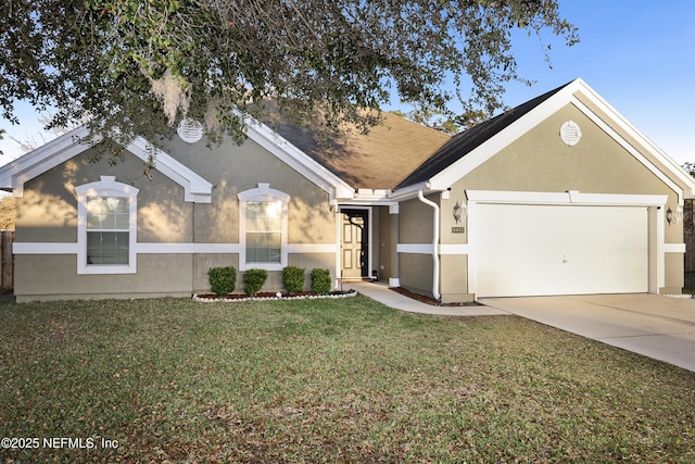 ranch-style home with a garage, driveway, a front yard, and stucco siding