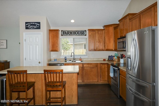 5452 Huckleberry Ct, Macclenny, FL 32063 - kitchen with appliances with stainless steel finishes, a sink, light countertops, brown cabinets, and recessed lighting