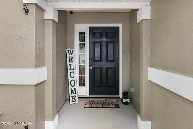 5452 Huckleberry Ct, Macclenny, FL 32063 - view of exterior entry featuring stucco siding