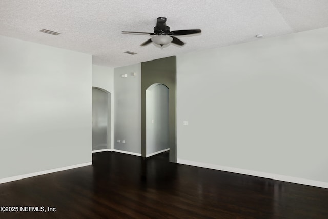 5452 Huckleberry Ct, Macclenny, FL 32063 - spare room with wood finished floors, ceiling fan, arched walkways, a textured ceiling, and baseboards