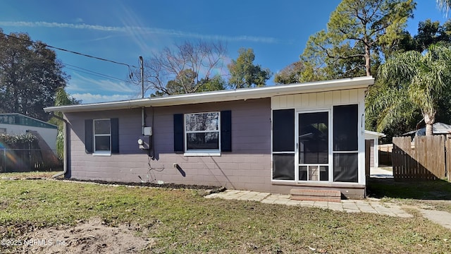 back of house featuring a yard