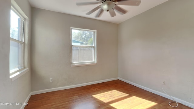 empty room with ceiling fan and light hardwood / wood-style floors