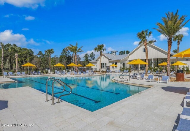 pool featuring a patio area and fence