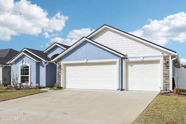 view of front facade with a garage and a front lawn