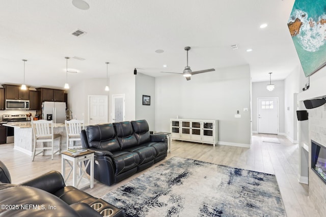 living room featuring light hardwood / wood-style flooring and ceiling fan