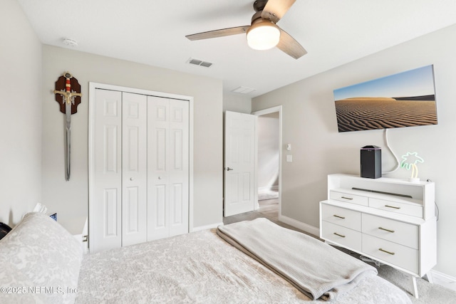 carpeted bedroom with ceiling fan and a closet