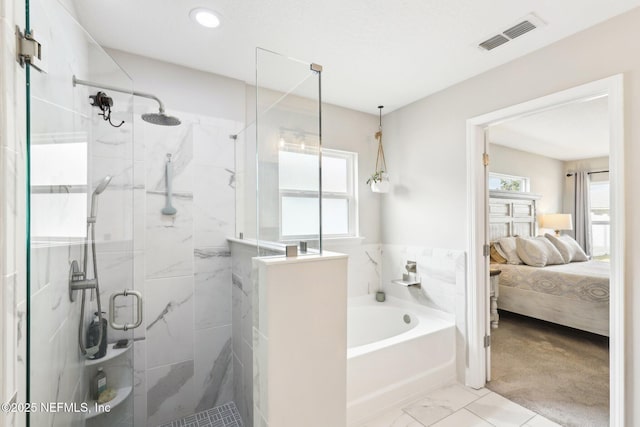 bathroom with shower with separate bathtub and a wealth of natural light