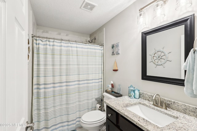 bathroom with walk in shower, vanity, toilet, and a textured ceiling