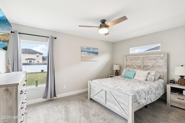 carpeted bedroom with ceiling fan and multiple windows