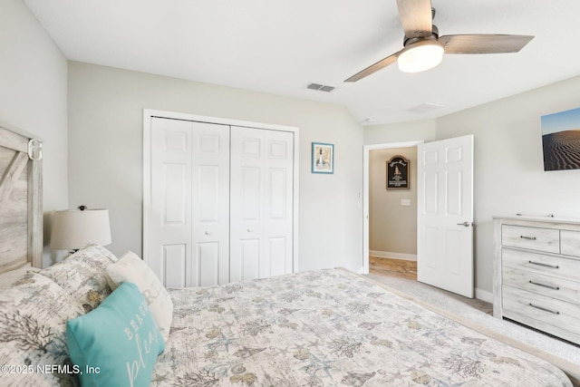 carpeted bedroom featuring ceiling fan and a closet