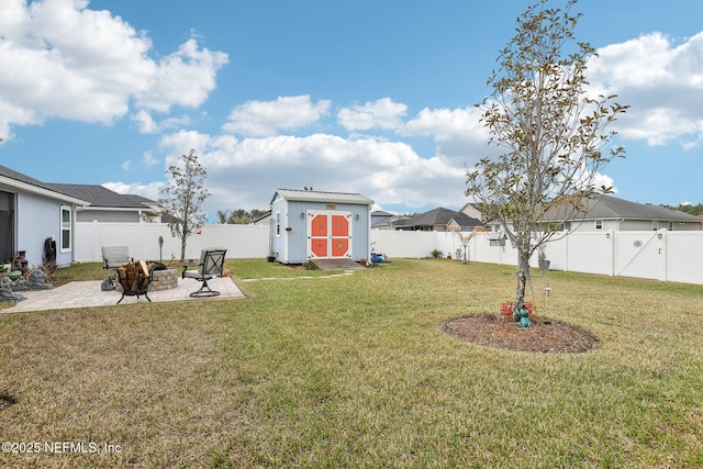 view of yard with a patio, a fire pit, and a shed