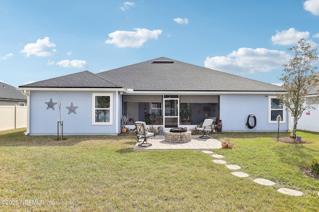 back of house featuring a fire pit, a patio area, and a lawn