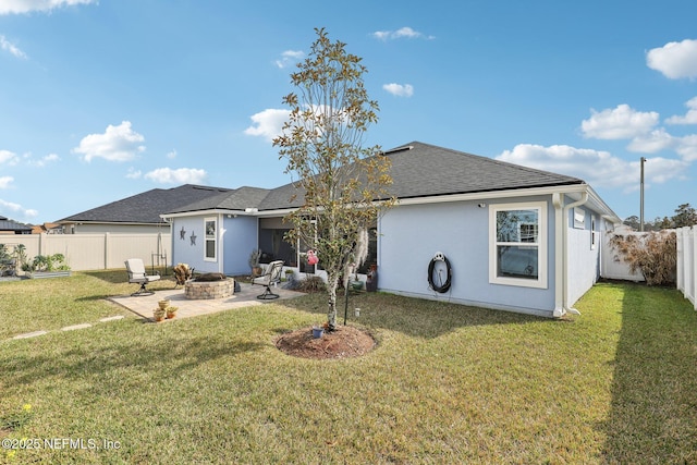 back of property featuring a patio, a yard, and a fire pit