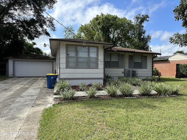 view of front of property featuring a garage, a front yard, and central air condition unit