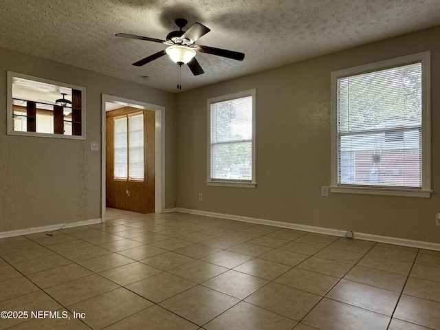 unfurnished room featuring ceiling fan, a textured ceiling, and light tile patterned floors