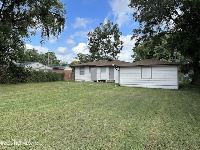 rear view of house with a lawn