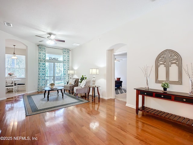 living room featuring hardwood / wood-style flooring and ceiling fan