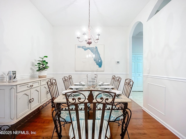 dining room featuring dark hardwood / wood-style flooring and a notable chandelier