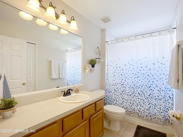 bathroom with tile patterned flooring, vanity, walk in shower, and toilet